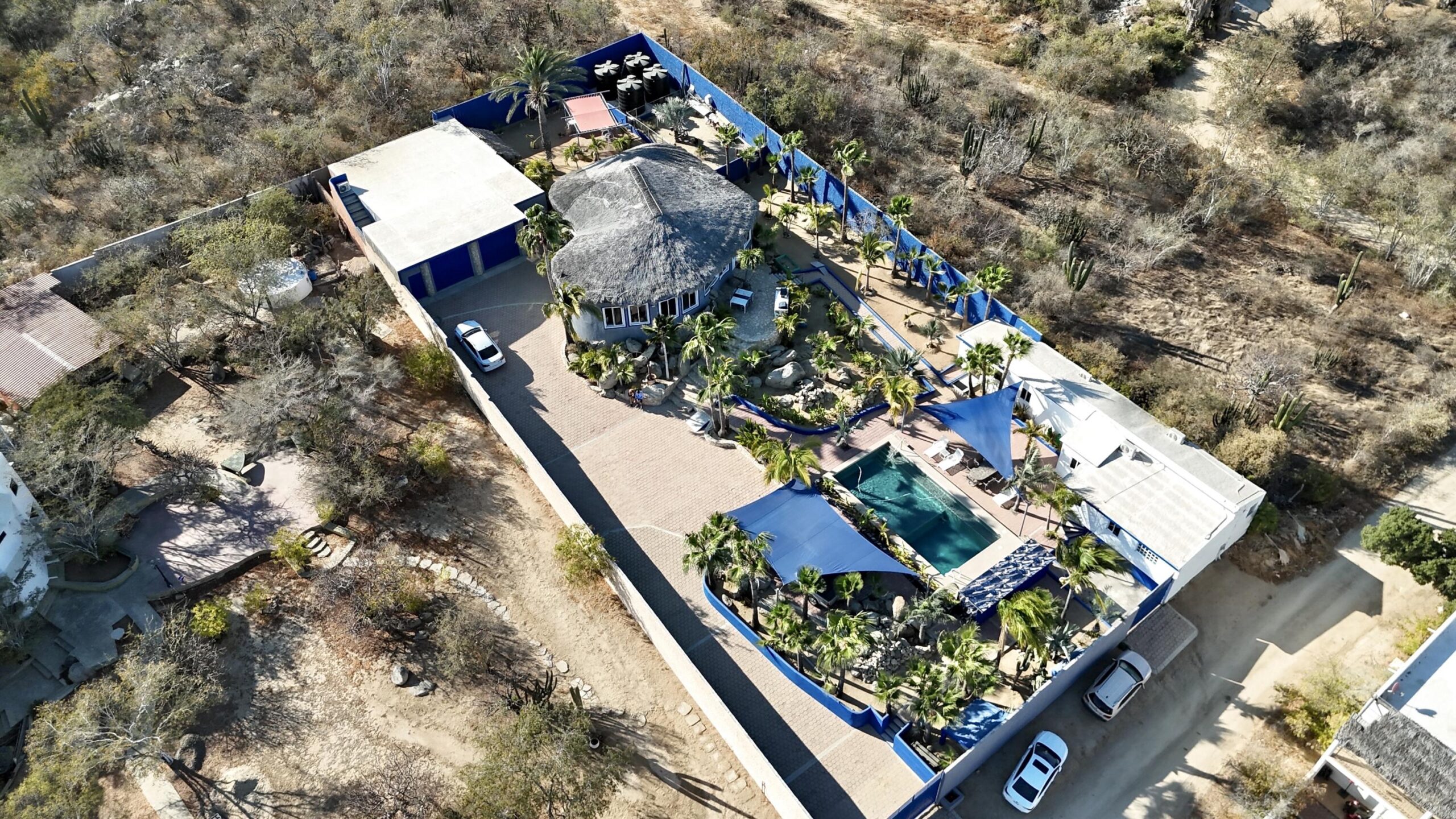 Los Cabos Brisas Del Pac East Rare opportunity to own a large Cabo property in a prime location close to the highway, shopping, hospitals, and schools. This unique compound offers multiple buildings with room for expansion and incredible rental income potential.The main home is an authentic Cabo-tyle house at the center of the property. A separate casita can easily be converted into two condos, ideal for generating rental income. The property also includes a large garage and workshop, with a flat buildable pad above the garage--perfect for another home or condos with stunning for sale