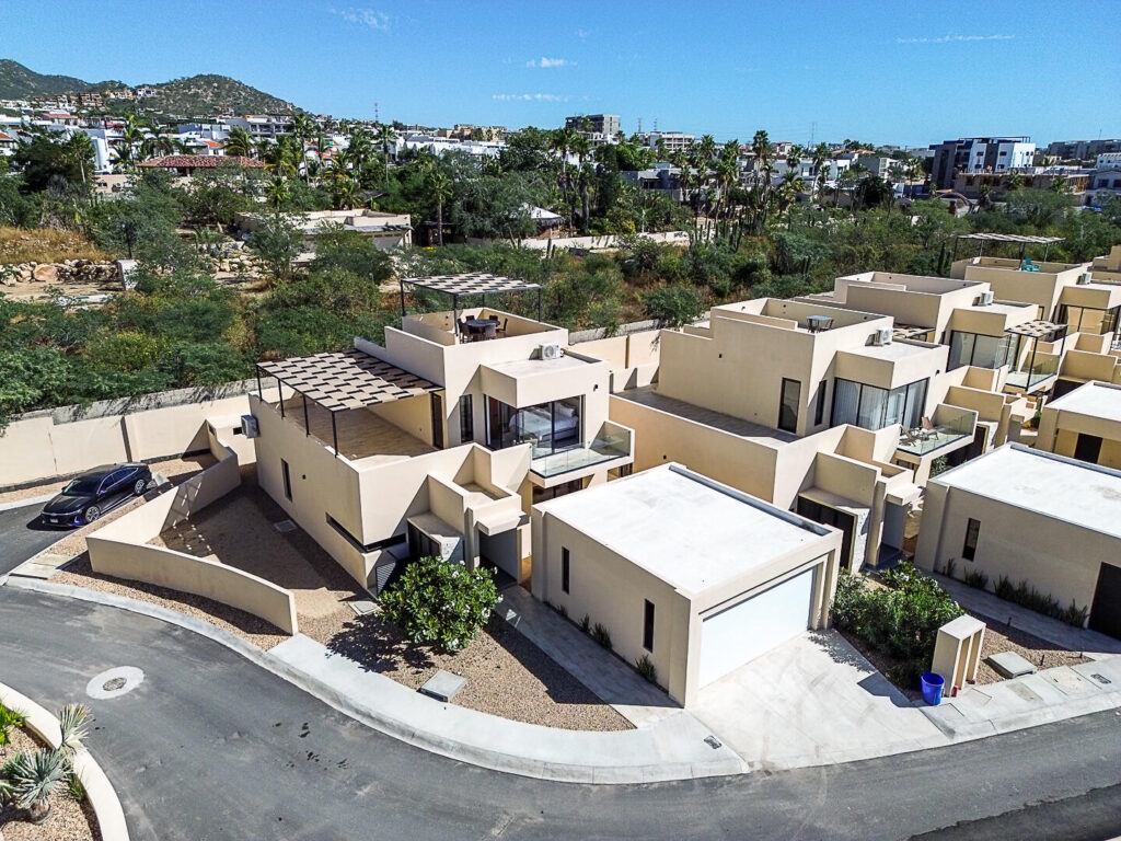 Los Cabos Cumbre Del Tezal Move-in ready and fully furnished. 2,045 sq ft of construction on a 2,551 sq ft lot with 3-car parking. Luxury finishes include marble flooring, wood kitchen with granite countertops, built-in wooden closets in all bedrooms, and vanities with tempered glass shower doors in all 3.5 baths. Fully equipped with 5 Gree inverter mini-split A/C units (3 × 1-ton, 2 × 2-ton), LG 22' French Door refrigerator, Whirlpool gas stove, and 1.7 cu ft microwave hood. Additional features: rooftop with bar, grill & sink, private terrace, storage, WiFi smart lock, private 5,000-liter cistern, and termite prevention system. ommunity: pool, gym, sports courts, kids' area, 3 clubhouses & 24/7 gated security for sale